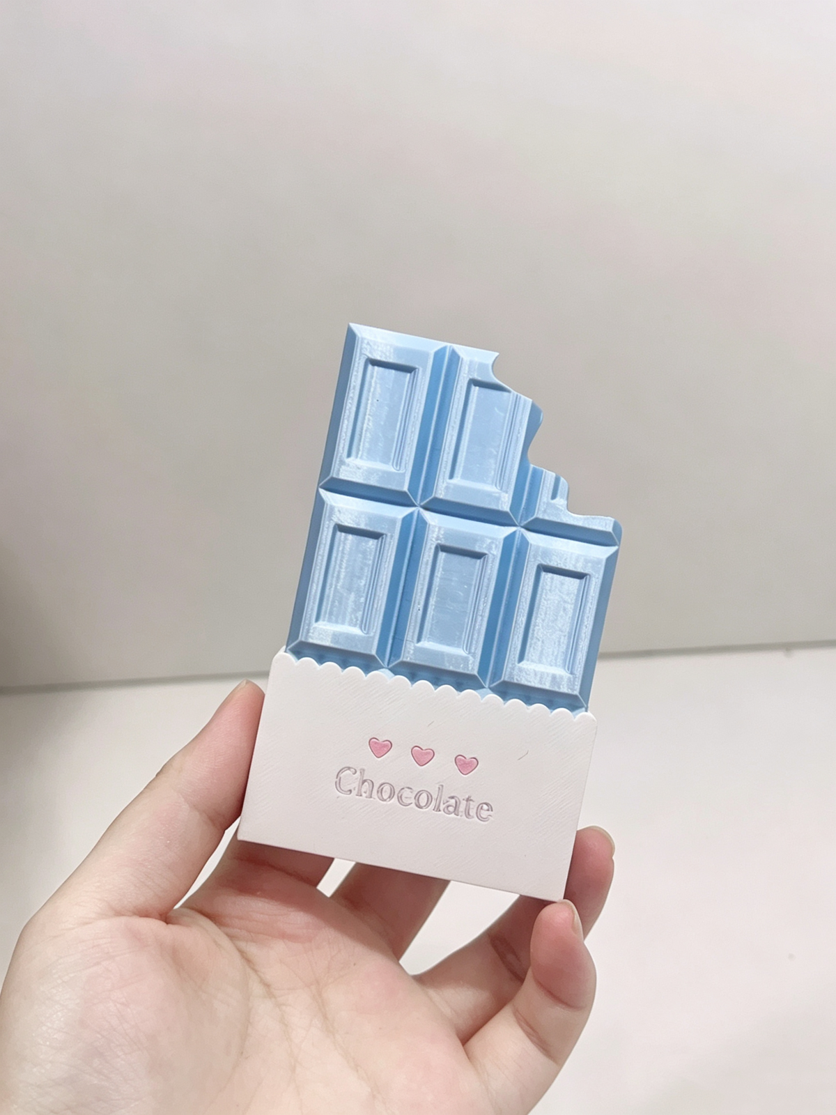 Blue chocolate bar card holder with a white wrapper