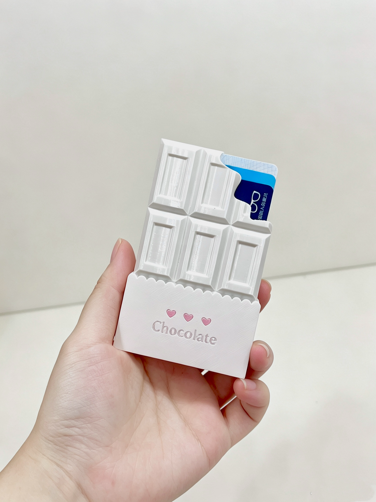 White chocolate card holder securely holding two standard cards